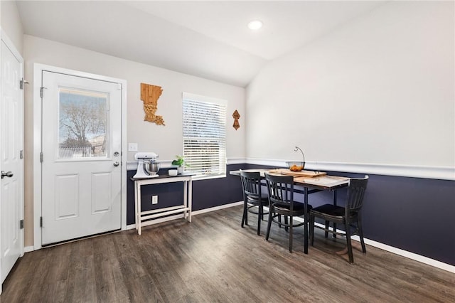 dining room with dark wood-type flooring and lofted ceiling