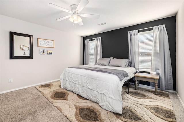 carpeted bedroom featuring ceiling fan and multiple windows