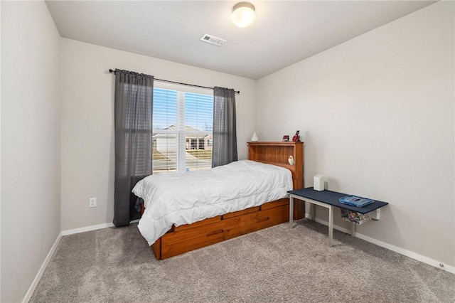 carpeted bedroom with visible vents and baseboards