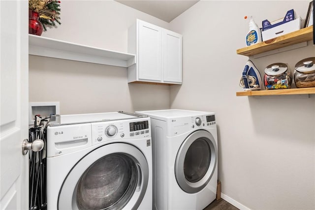 clothes washing area featuring cabinets and washing machine and dryer