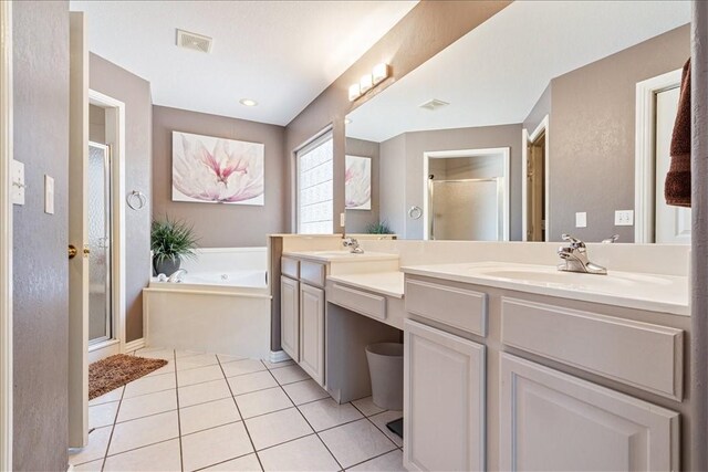 bathroom featuring separate shower and tub, vanity, and tile patterned flooring