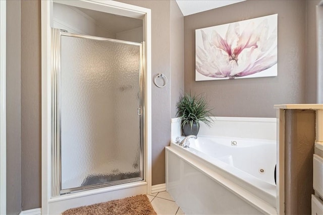 bathroom with tile patterned floors and shower with separate bathtub