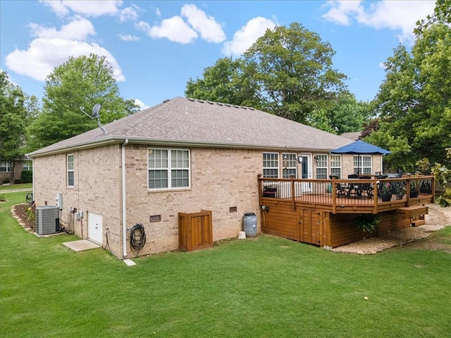 rear view of house with a wooden deck, a lawn, and central air condition unit