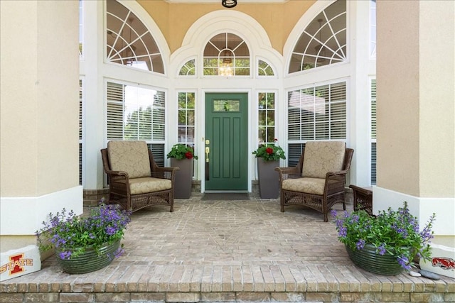 view of exterior entry featuring stucco siding