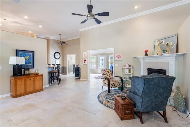 living room with ceiling fan and crown molding