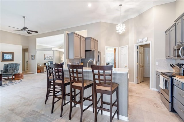 kitchen featuring ceiling fan, gray cabinets, and stainless steel appliances