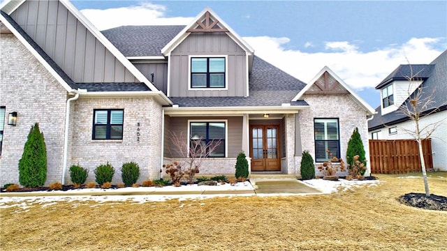 view of front of home with a front lawn and french doors