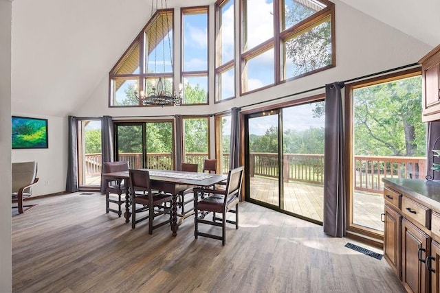 dining space with a high ceiling and hardwood / wood-style flooring