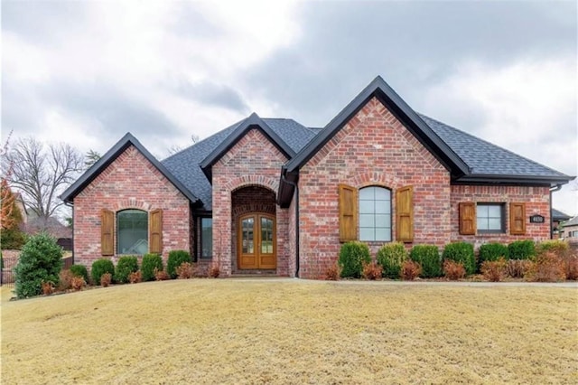 view of front of home featuring a front lawn and french doors