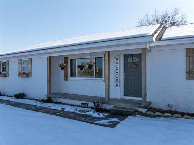 view of snow covered property entrance