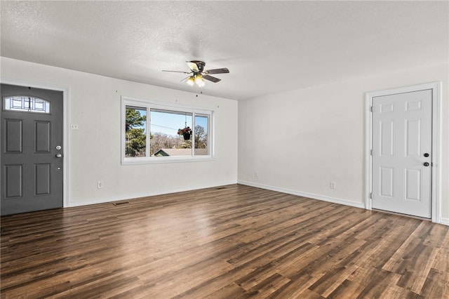 entryway featuring ceiling fan, dark hardwood / wood-style flooring, and a textured ceiling