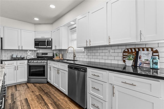 kitchen with dark wood-type flooring, sink, white cabinets, and appliances with stainless steel finishes