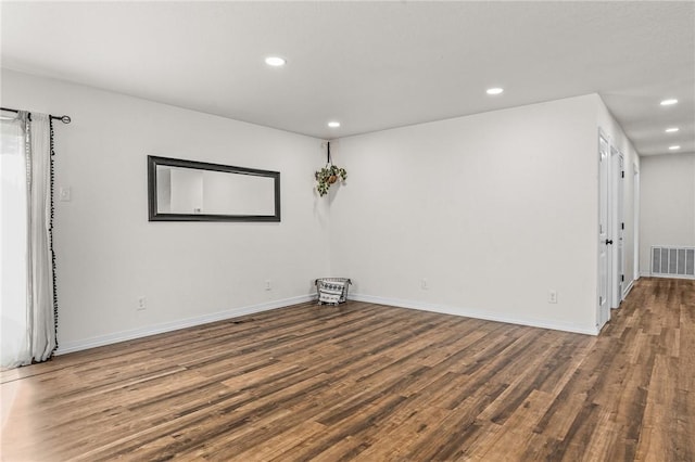 empty room featuring dark hardwood / wood-style flooring