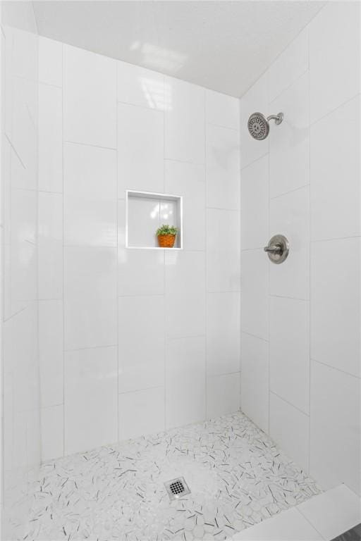 bathroom with a tile shower