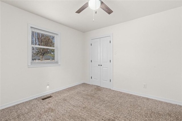 spare room featuring carpet floors and ceiling fan