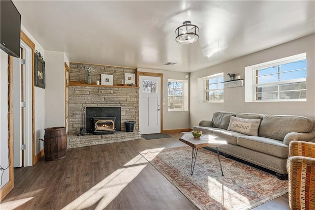 living room with a wood stove and hardwood / wood-style flooring