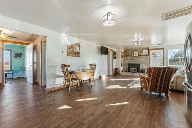 living room with a wood stove and dark hardwood / wood-style floors