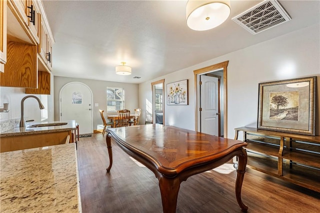 dining space with dark hardwood / wood-style flooring and sink