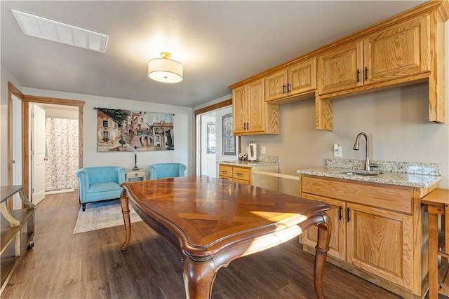 kitchen with light stone countertops, dark hardwood / wood-style floors, and sink