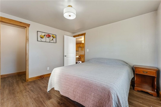 bedroom with dark hardwood / wood-style floors