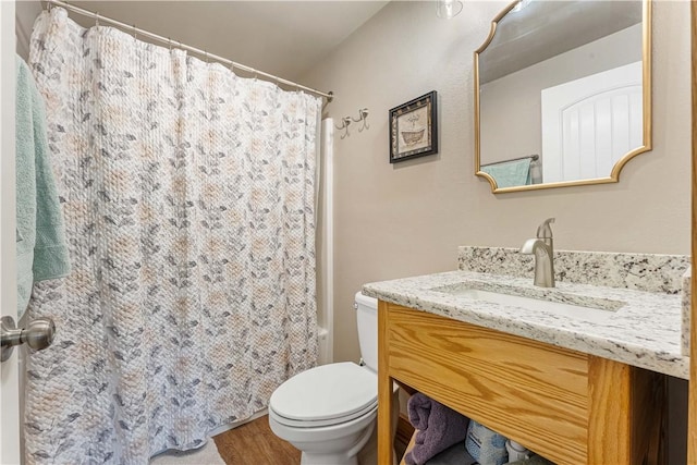 full bathroom with toilet, shower / tub combo, hardwood / wood-style flooring, and vanity