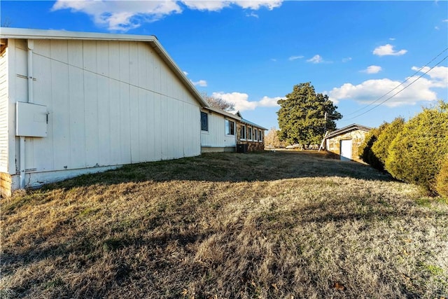 view of home's exterior featuring cooling unit and a yard