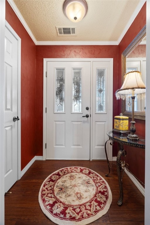 entrance foyer with crown molding, dark hardwood / wood-style floors, and a textured ceiling