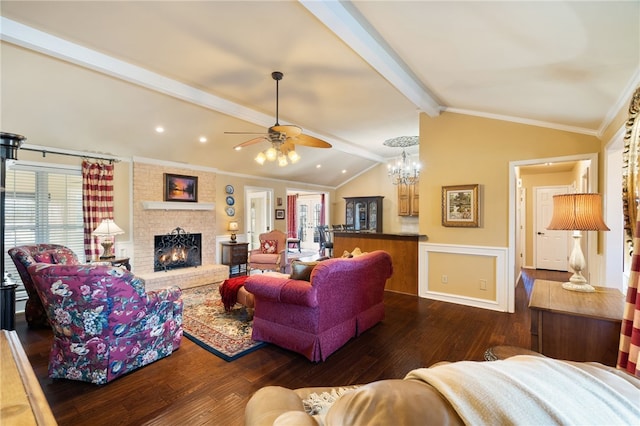 living room with dark hardwood / wood-style flooring, vaulted ceiling with beams, crown molding, and a fireplace