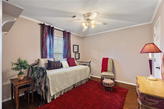 bedroom with ceiling fan, ornamental molding, dark hardwood / wood-style floors, and a textured ceiling