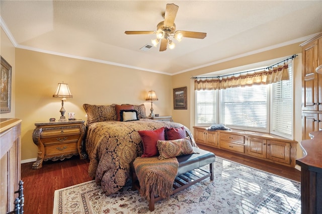 bedroom featuring dark hardwood / wood-style flooring, ornamental molding, and ceiling fan