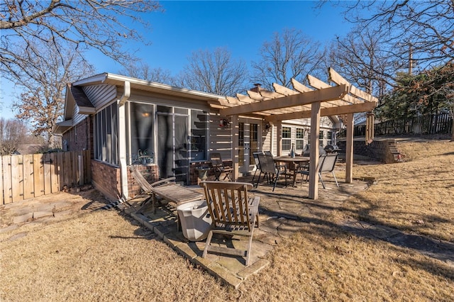 rear view of property featuring a pergola and a patio