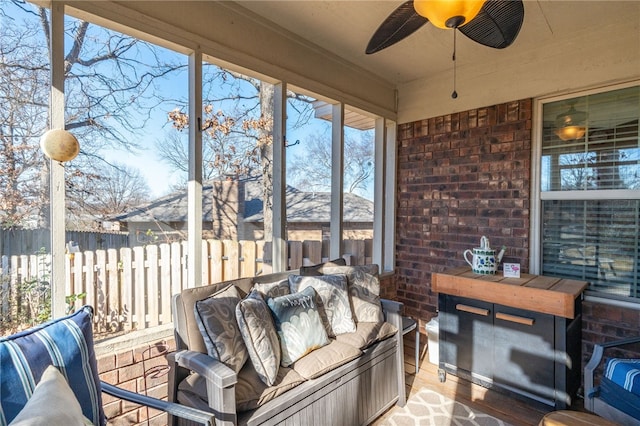 sunroom / solarium featuring ceiling fan