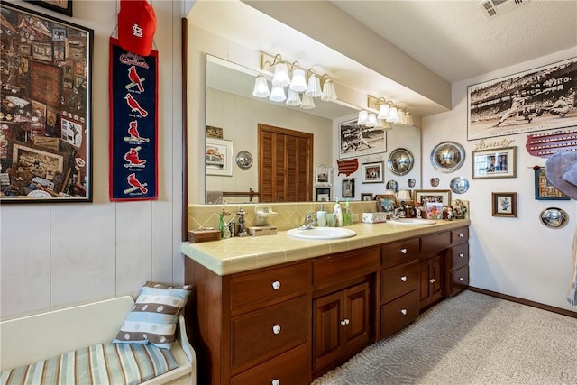 bathroom featuring vanity, a chandelier, and a textured ceiling