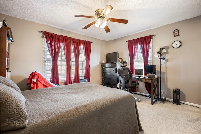 carpeted bedroom with a textured ceiling and ceiling fan