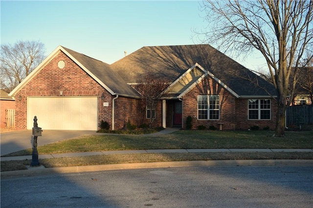 view of front of property featuring a garage and a front lawn