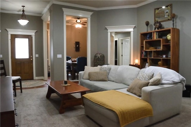 living room featuring crown molding, carpet, and ceiling fan