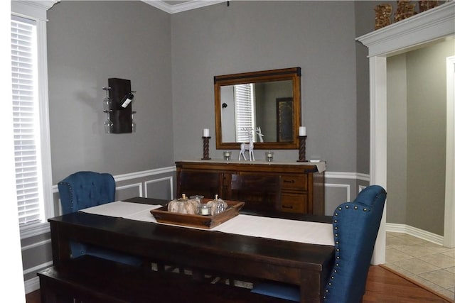 tiled dining space featuring ornamental molding and sink