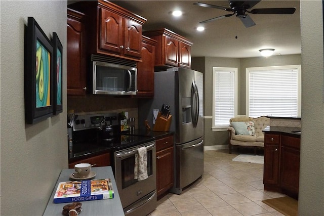 kitchen featuring backsplash, ceiling fan, stainless steel appliances, and light tile patterned floors