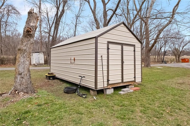 view of outbuilding with a yard