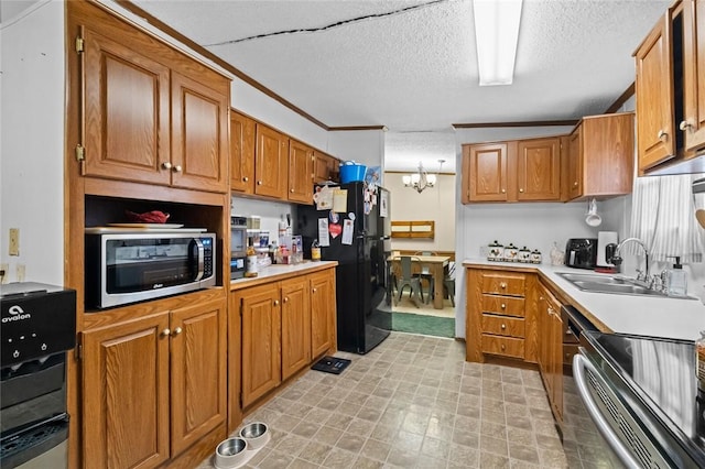 kitchen featuring black fridge, stove, sink, a textured ceiling, and a chandelier