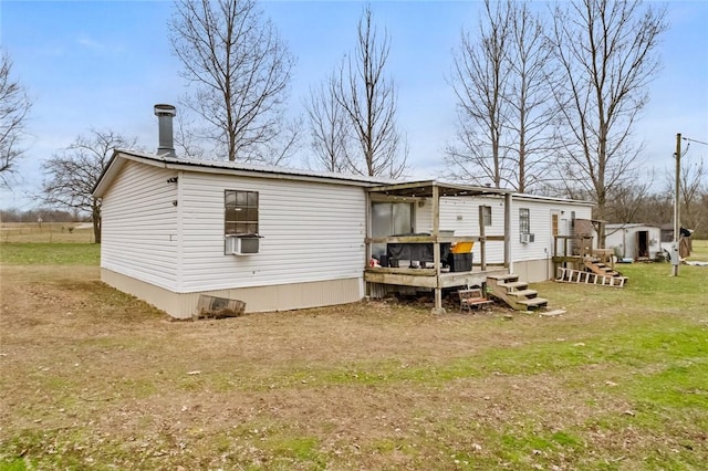 rear view of house with a yard