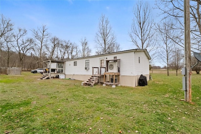 rear view of house featuring a lawn