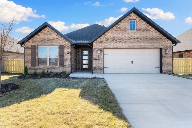 view of front of house with a garage and a front lawn