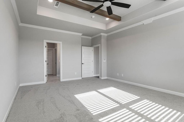 unfurnished bedroom with ceiling fan, light carpet, a tray ceiling, and ornamental molding