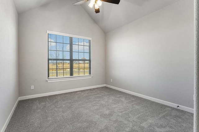 carpeted spare room featuring vaulted ceiling and ceiling fan