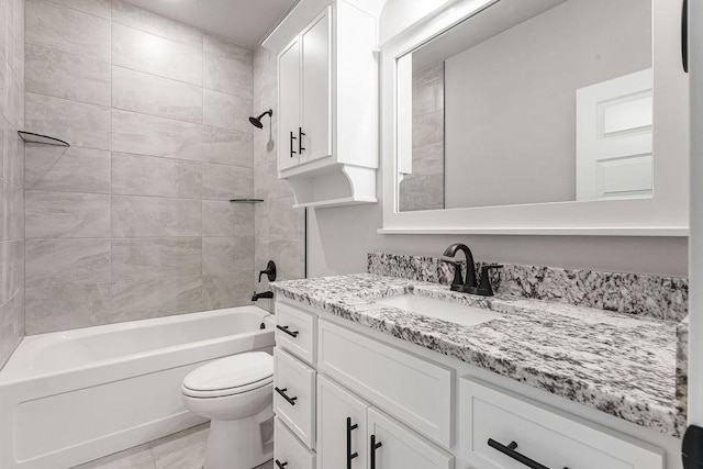 full bathroom with toilet, vanity, and tiled shower / bath