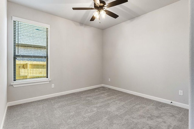 spare room with ceiling fan, a healthy amount of sunlight, and light colored carpet