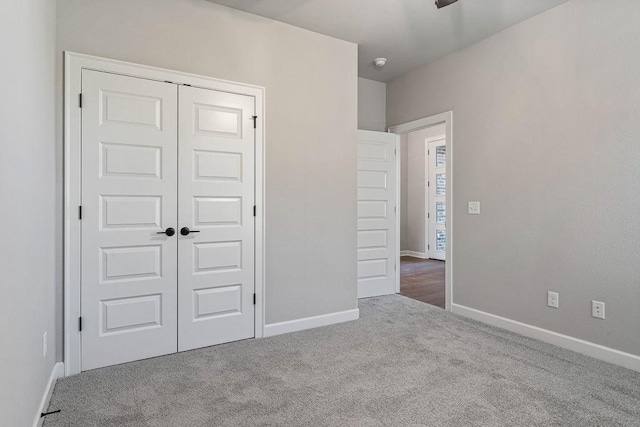 unfurnished bedroom with a closet and carpet flooring