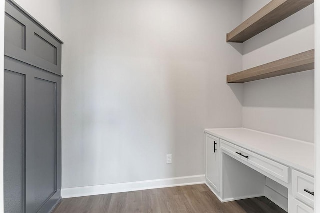 unfurnished office with dark wood-type flooring