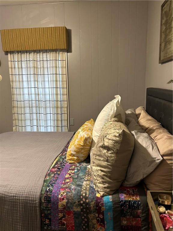 bedroom with wooden walls